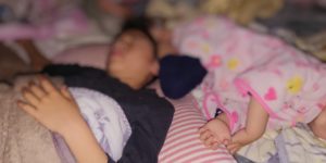 夜中起きてしまう子供が寝相悪く蹴られているところ